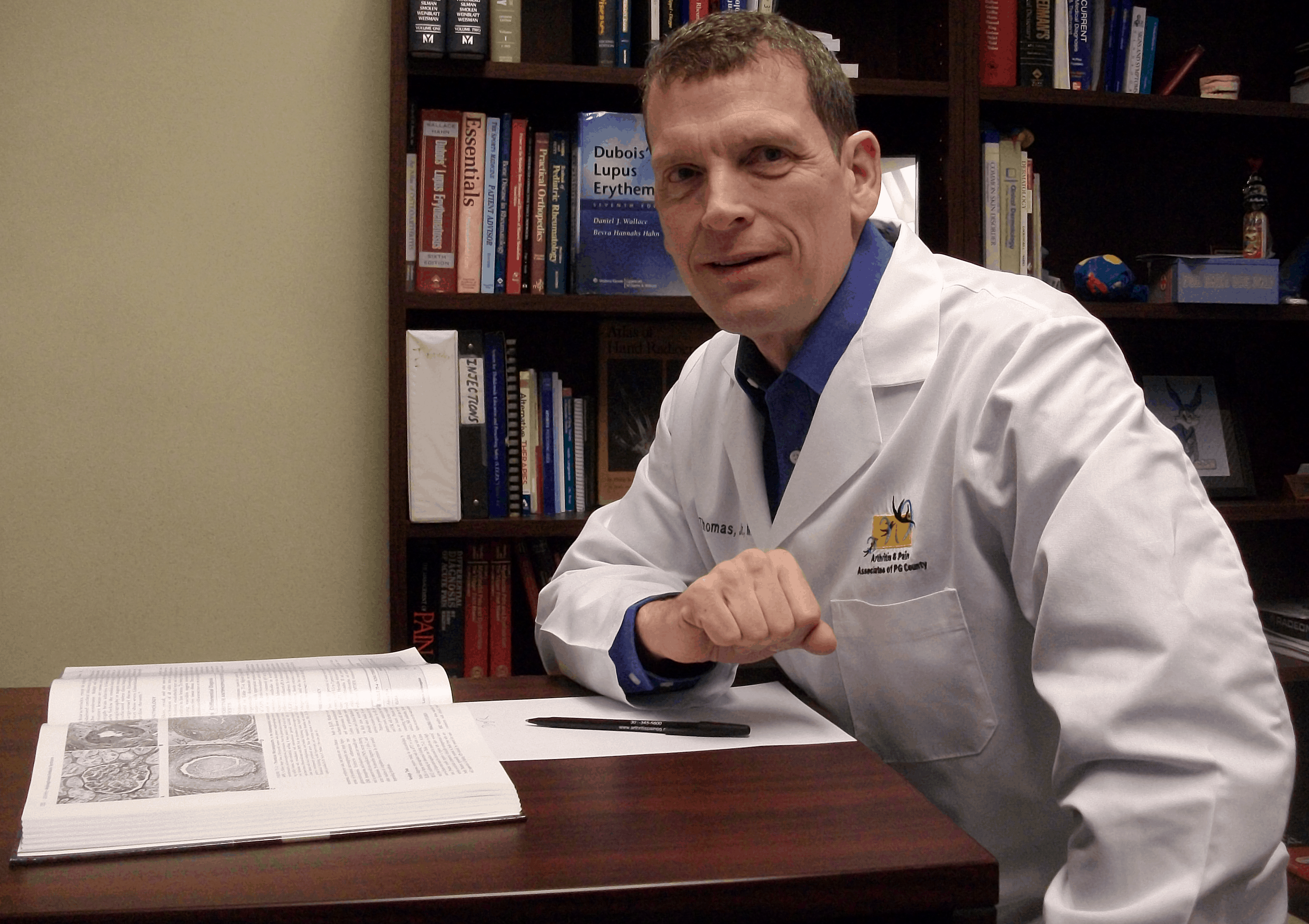 Donald Thomas, MD reading a book while writing The Lupus Encyclopedia and The Lupus Secrets