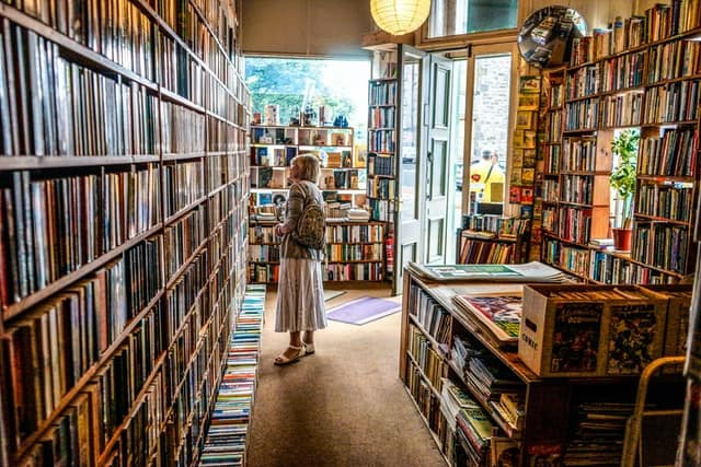 A woman looking at bookshelves